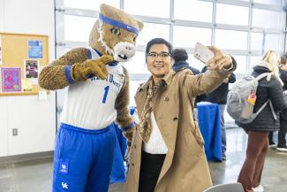 The Wildcat taking a selfie at the event with an attendee.