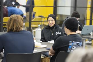 Cybersecurity interns networking with attendees.