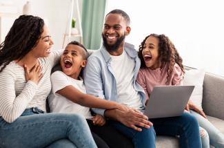 Happy Family around laptop
